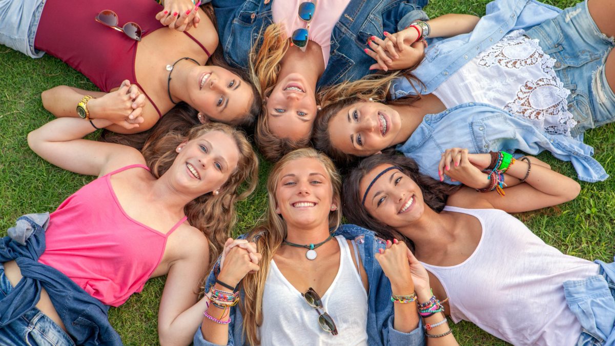 happy smiling group of diverse girls at summer camp